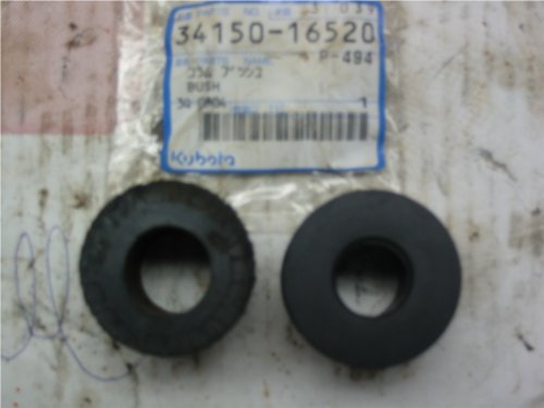 A view of two upper steering column bushings. Notice the worn out one one the left has lost its shape and is a bit oblong - a result of turning and steering a Kubota over many years.