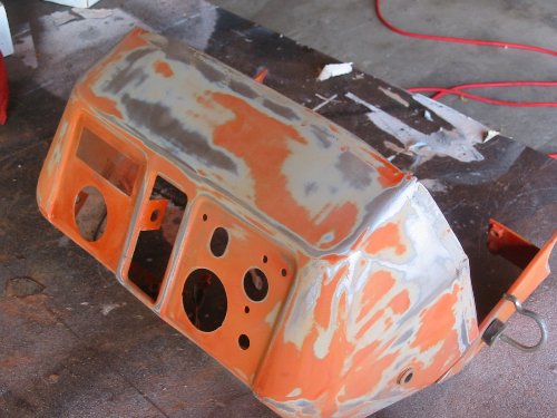 The dash of a Kubota after orbital sanding with 60, 120 and 180 grit sandpaper. Some areas have bare metal exposed which will be covered during the priming process.