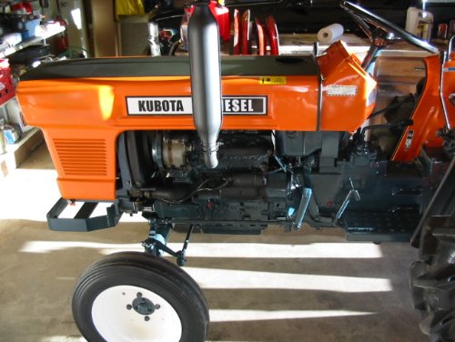 Kubota L2000 with restored paint A side shot of the L2000 detailing the painted frame, muffler and stack, wheels and installed decals