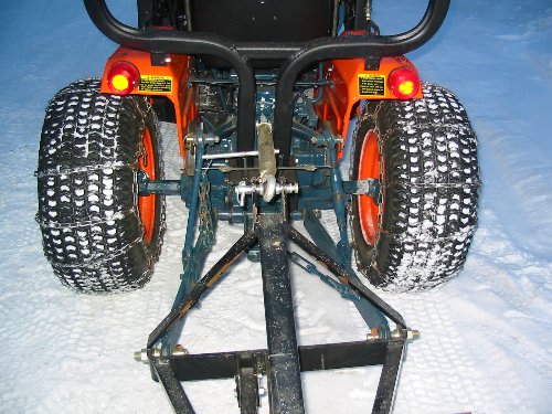 Rear View Tire Chains Tire chains installed on the turf tires of this B6200 boost traction enough for us to use a snow blade to clear the driveway.