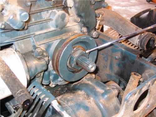 Removing Engine Balancer Pulley Removing the front engine balancer pulley requires removing a 46mm nut. The PTO shaft sticks out so a deep socket (at least 2" or more) is needed. We fabricated our own socket for this task.