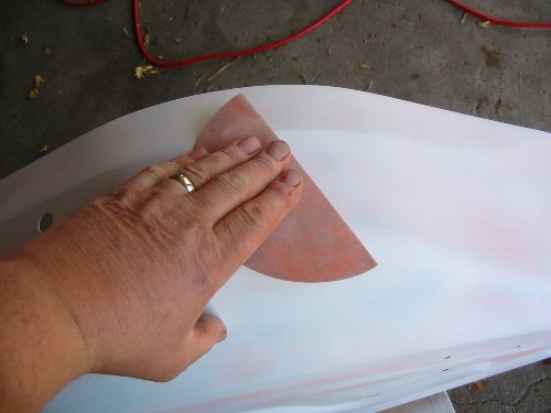 Sanding after primer Use your hands to feel the finish after priming and then take a 320 grit sandpaper to the fender after the second coat of primer. Eliminate any roughness you feel before painting.
