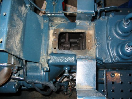 Steering box dowels. A shot looking down just after the steering box is removed from the top of the clutch housing. The male and female dowels are visible on the left and right as well as the 4 bolt holes where the box was held in place. The clutch shaft is visible in the openening.